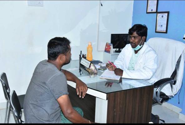 Dentist consulting a patient at Dhriti Dental